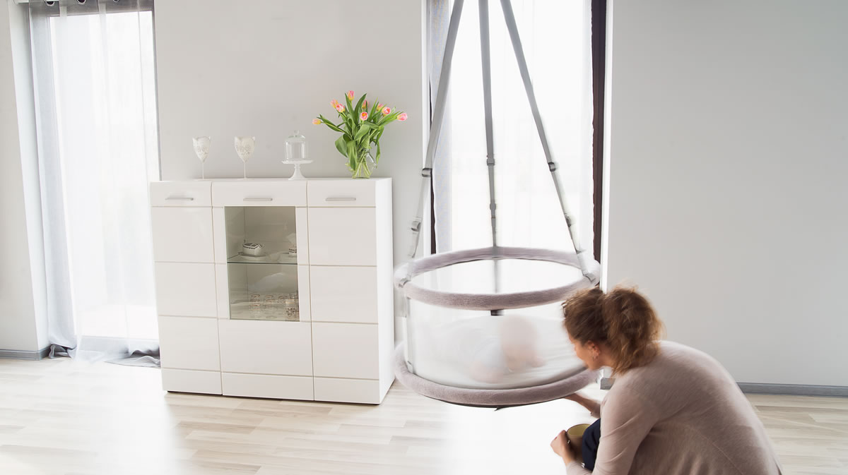 Leżenie na brzuszku baby bawi się w kołysce Memola